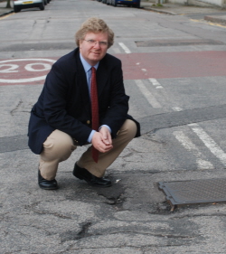 Photo of Ian Yuill and pothole